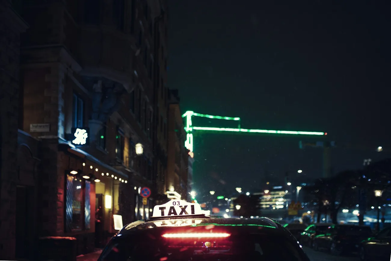 Taxi on a Stockholm street at night; illustrative stock photograph
